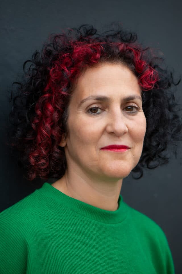 Benita Matofska, sustainability speaker looking at camera